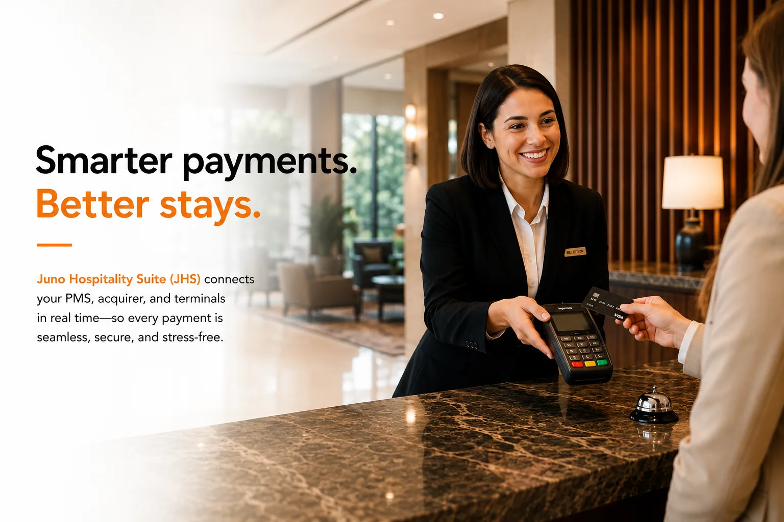 Front desk agent processing a card payment on a payment terminal in a modern hotel lobby